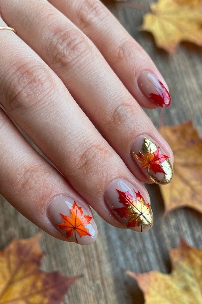 Red maple leaves on sheer nude nails