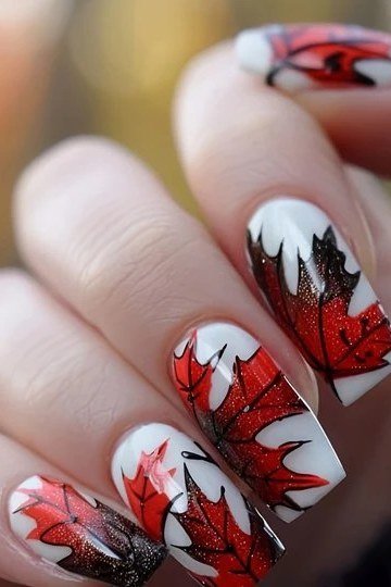 Bold red maple leaf nail art on long white nails