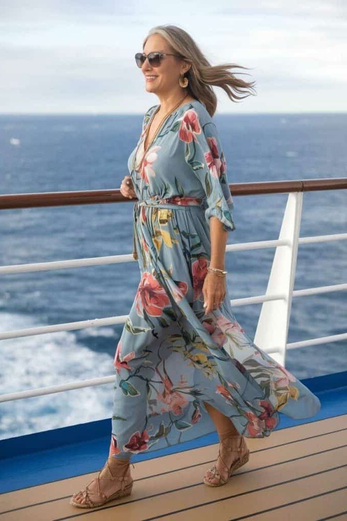 Teal floral maxi dress with kimono sleeves and a flowing skirt, walking a cruise ship deck; breezy botanical cruise dress - travel outfit for women over 50