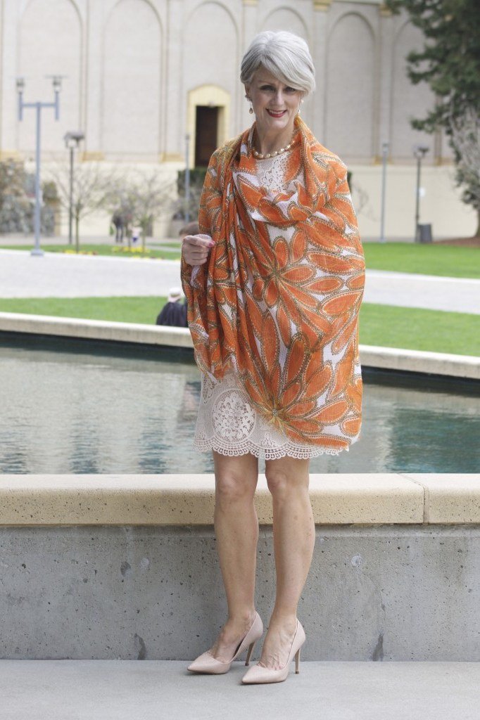 Orange-Print Shawl over a White Lace Dress, travel outfit for women over 70
