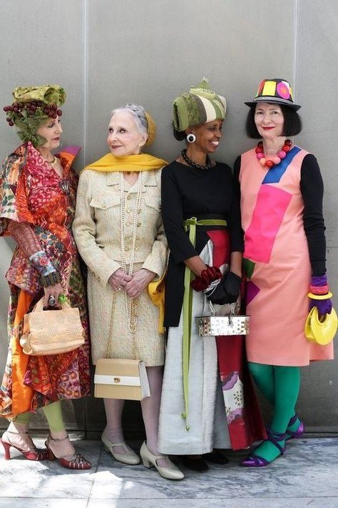 Four women in colorful hats and dresses together - trendy outfits for women over 70