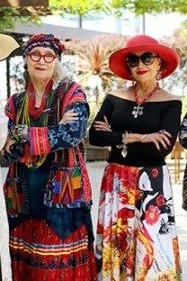 Four women in maxi dresses and hats together - trendy outfits for women over 70