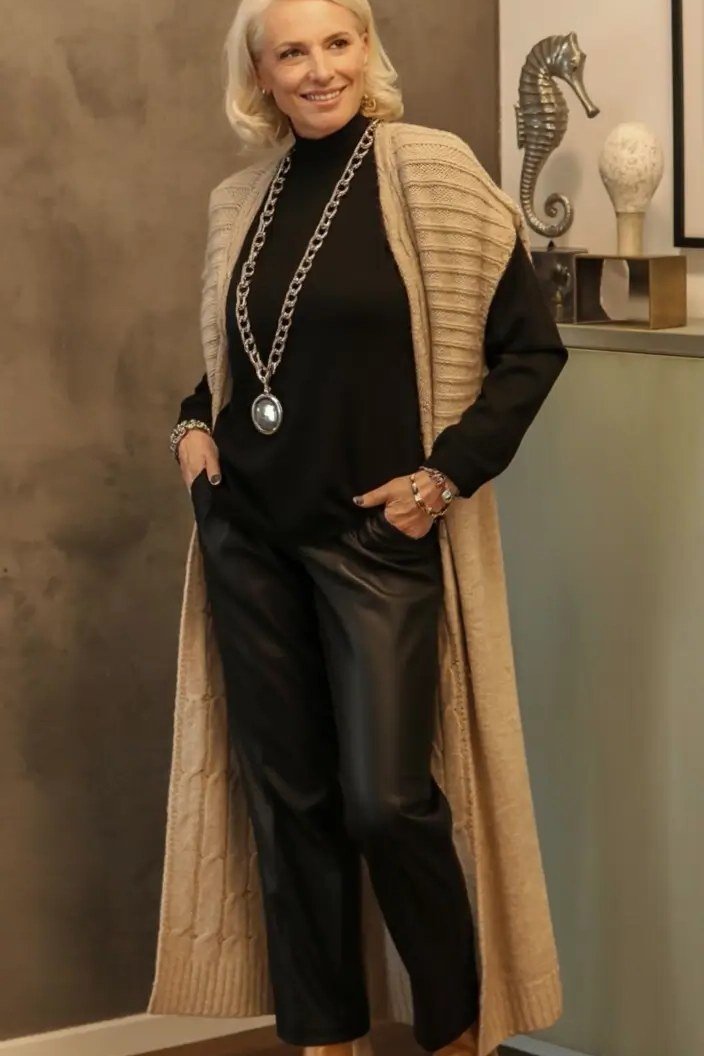 Fall turtleneck outfit for women over 50: black turtleneck with long tan cardigan, black leather pants