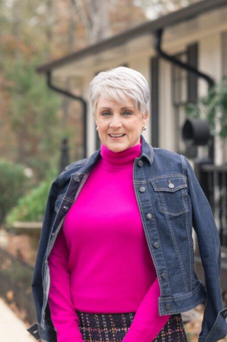 Fall turtleneck outfit for women over 50: magenta turtleneck with denim jacket, porch
