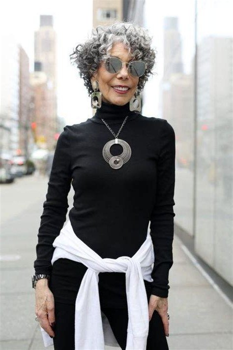 Fall turtleneck outfit for women over 50: black turtleneck with white shirt tied at waist, necklace, street