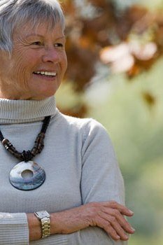 Fall turtleneck outfit for women over 50: light gray turtleneck with statement necklace, close-up