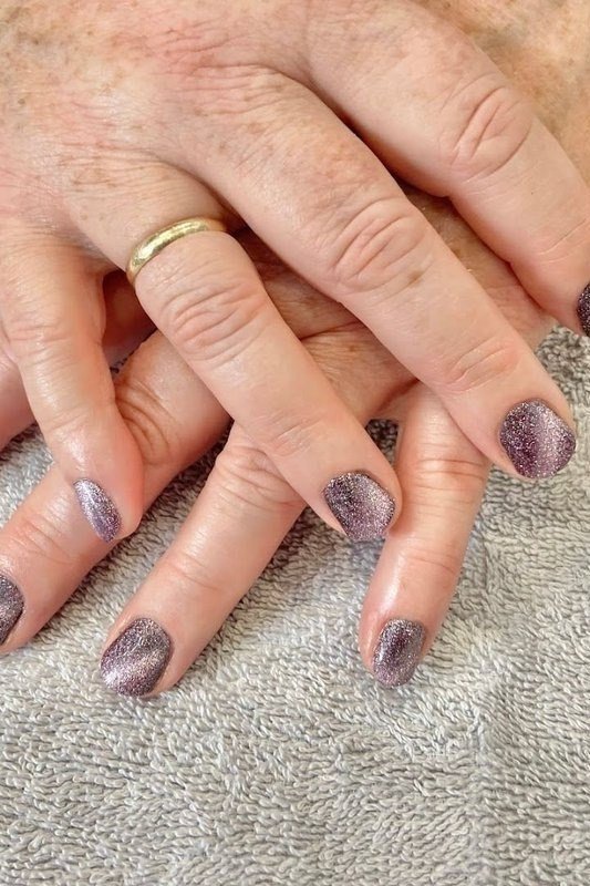 Mauve gray cat eye on mature hands - nail ideas for women over 40