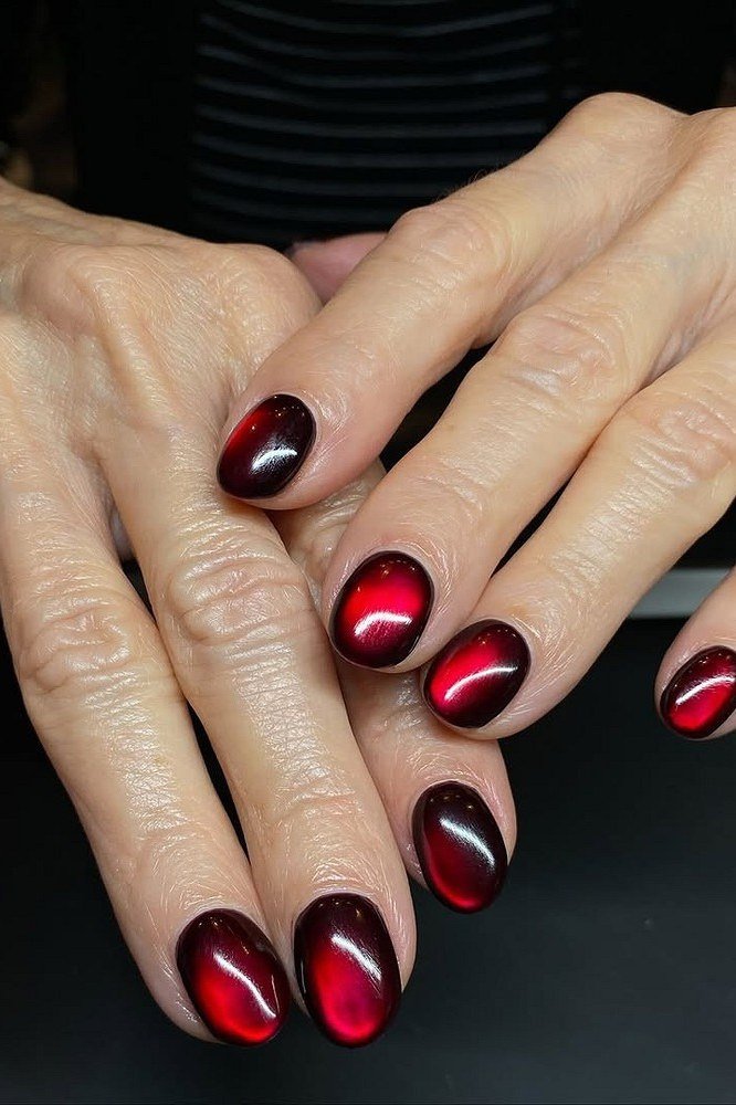 Black cherry cat eye on mature hands - nail ideas for women over 40