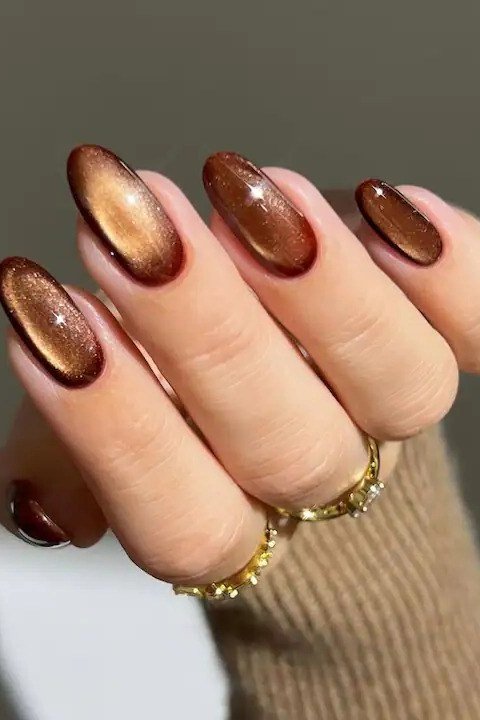 Burgundy copper velvet cat eye, short round, gold bangle - nail ideas for women over 40