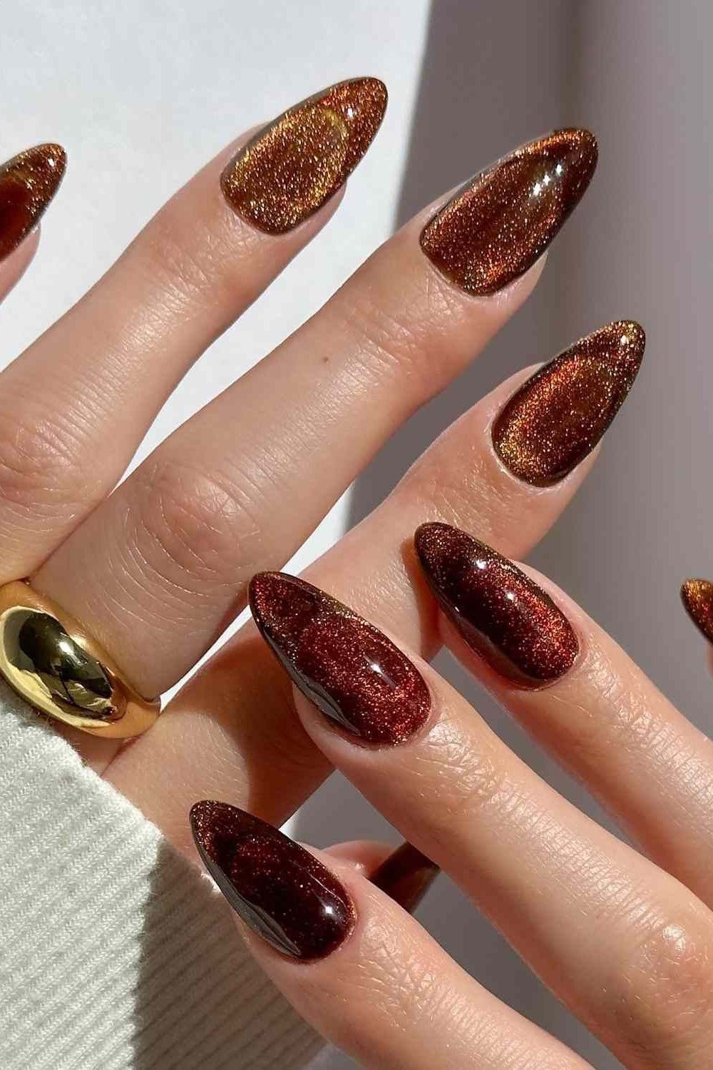 Copper glitter velvet cat eye, long almond - nail ideas for women over 40