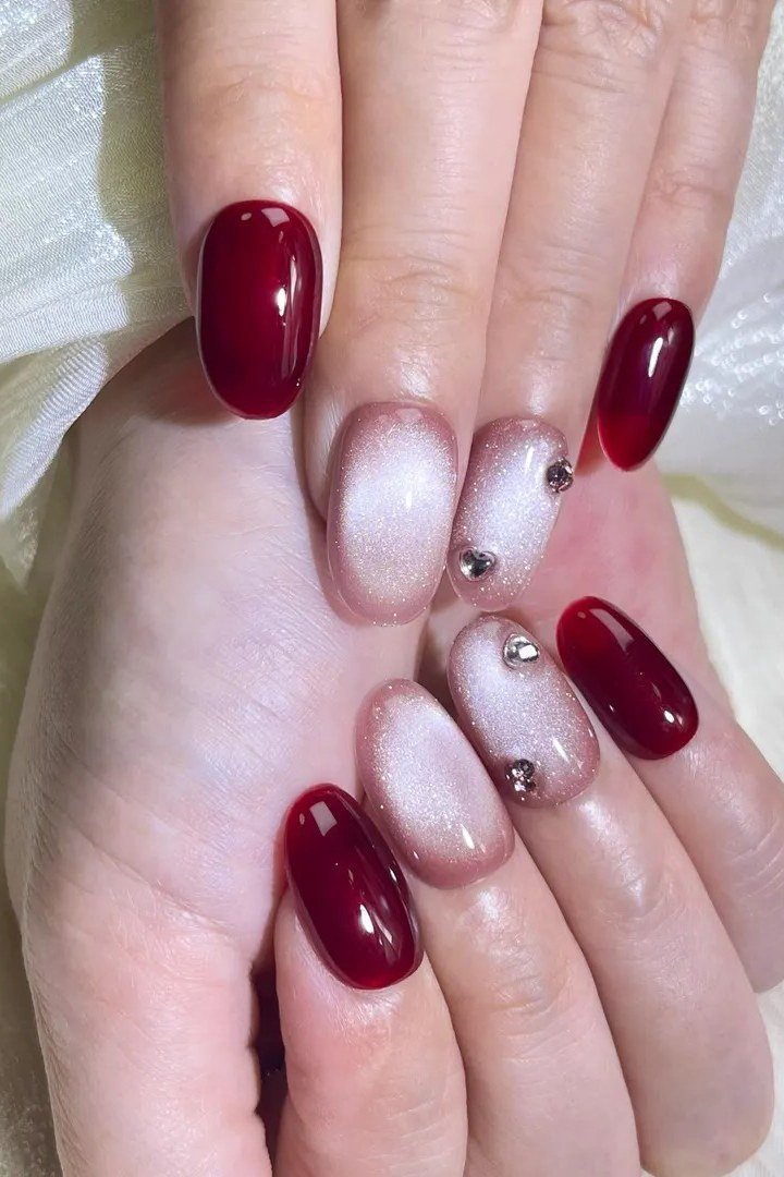Deep cherry red velvet cat eye, almond - nail ideas for women over 40