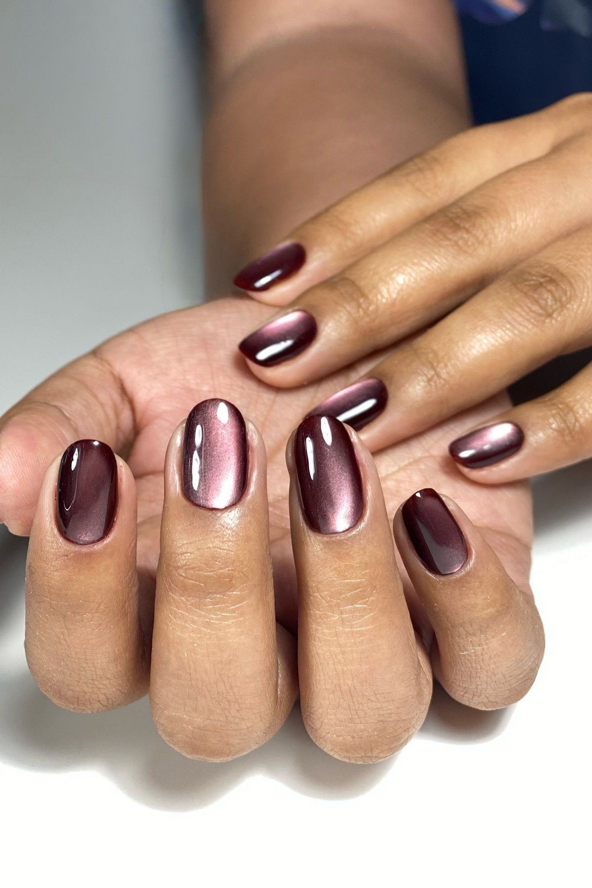 Plum black cherry velvet cat eye, oval, mature hands - nail ideas for women over 40