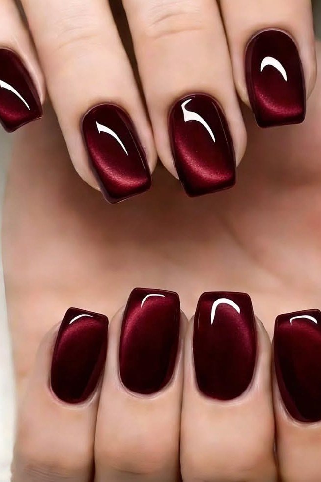 Deep burgundy velvet cat eye, short almond, glossy - nail ideas for women over 40