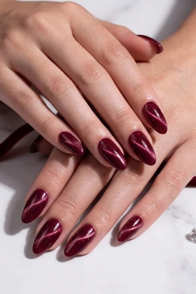 Classic burgundy velvet almond, elegant hands on marble - nail ideas for women over 40