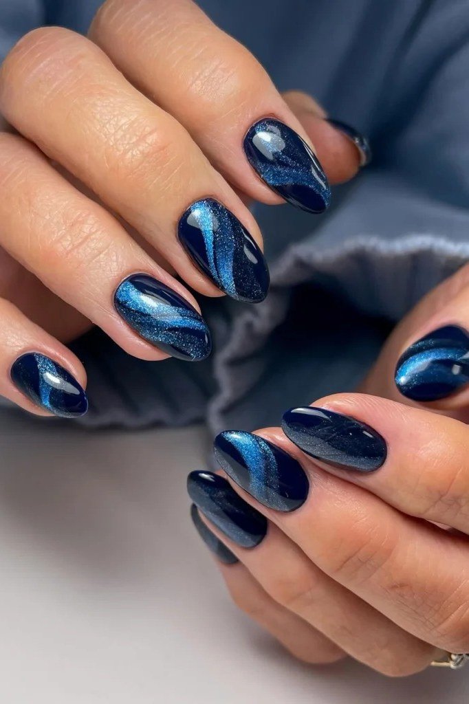 Navy cat eye almond, shimmering light band - nail ideas for women over 40