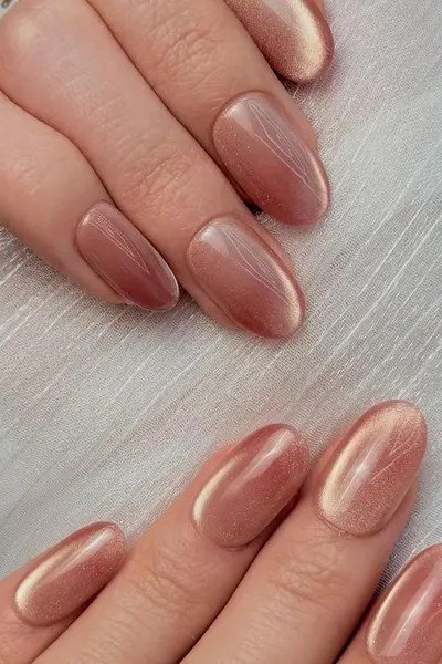 Rose gold nude cat eye almond, soft velvet shimmer - nail ideas for women over 40