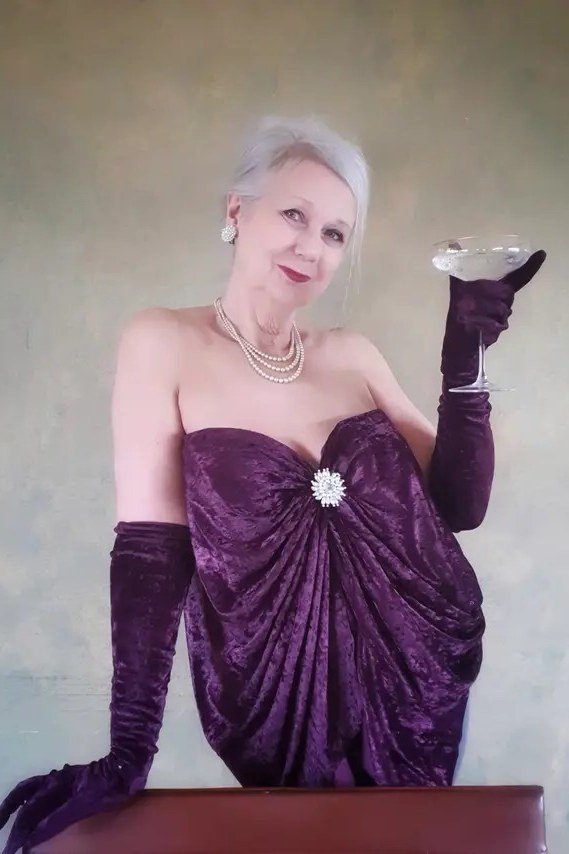 Purple Strapless Gown with Cocktail Glass - velvet evening outfit for women over 60