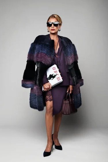 Winter outfit idea 16 for women over 60: purple fur coat with purple dress and clutch