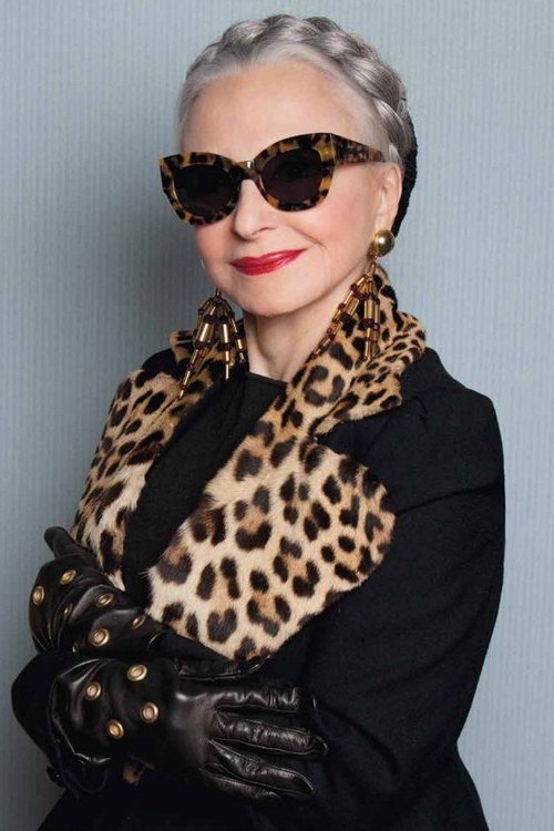 Winter outfit idea 23 for women over 60: black coat with leopard scarf and sunglasses