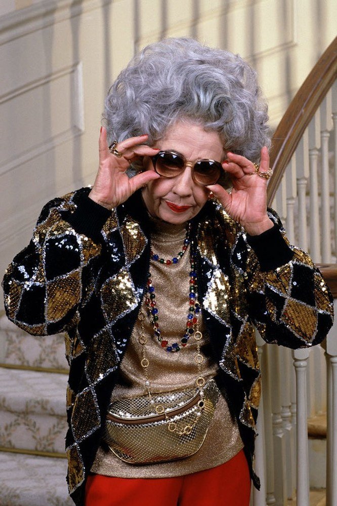 Winter outfit idea 28 for women over 60: black gold sequin jacket with red trousers