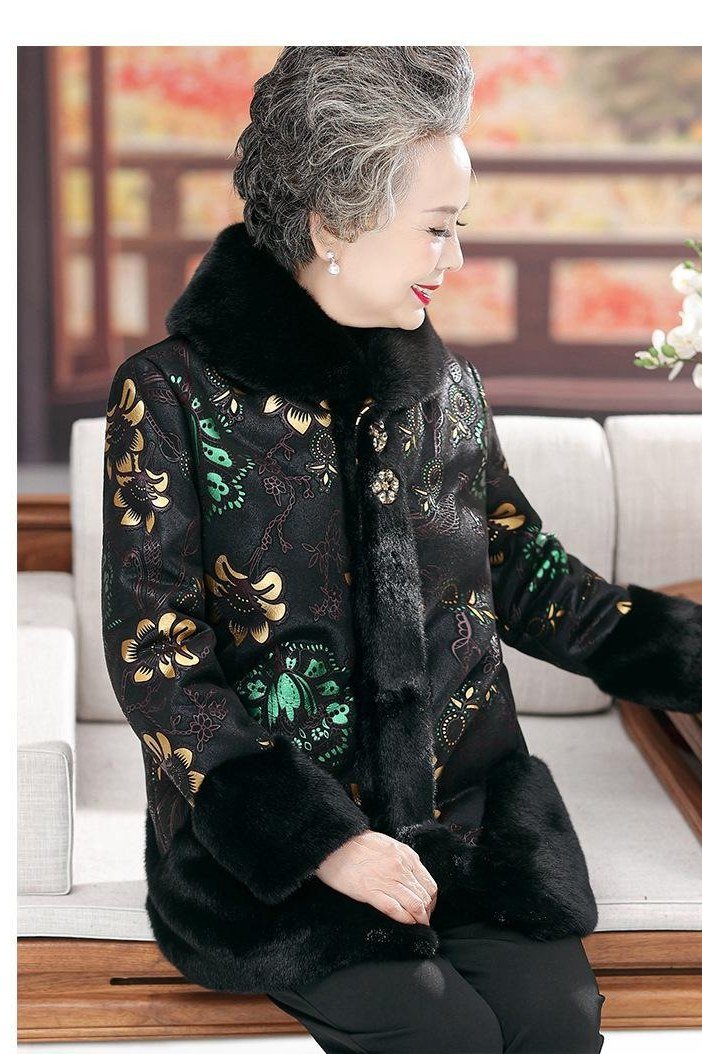 Winter outfit idea 29 for women over 60: black floral brocade coat, seated
