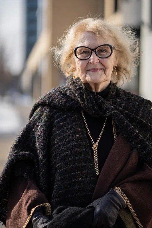 Winter outfit idea 30 for women over 60: dark shawl poncho with glasses, evening