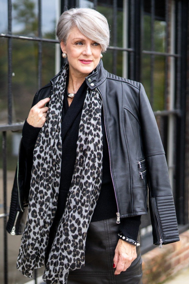 Winter outfit idea 48 for women over 60: black leather jacket with leopard scarf