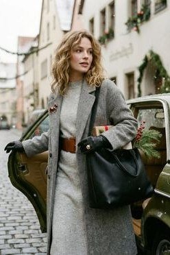 Winter outfit idea 65 for women over 60: grey coat with rust belt, vintage car