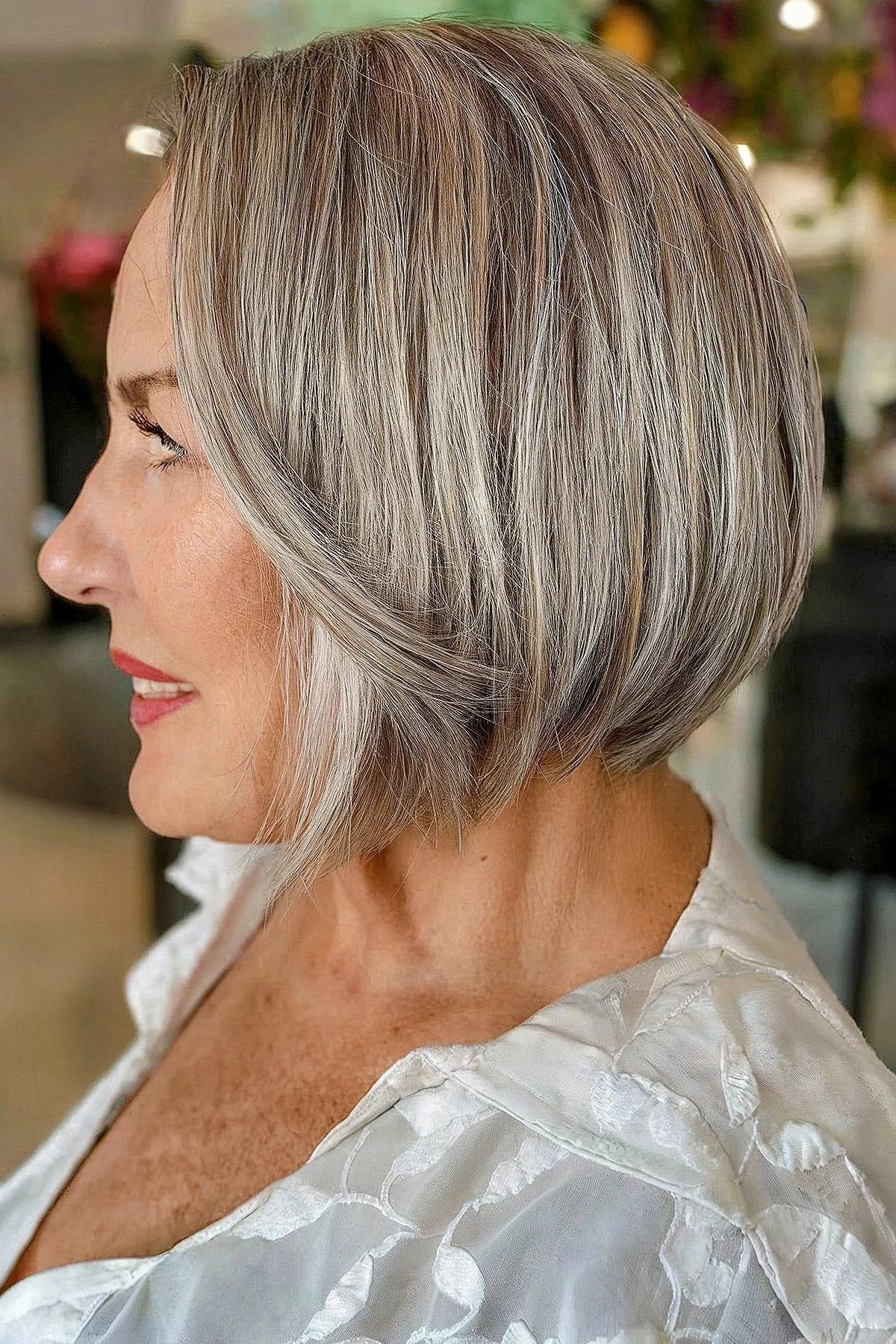Silver layered bob, side view, mature woman - voluminous layered bob hairstyle for women over 50