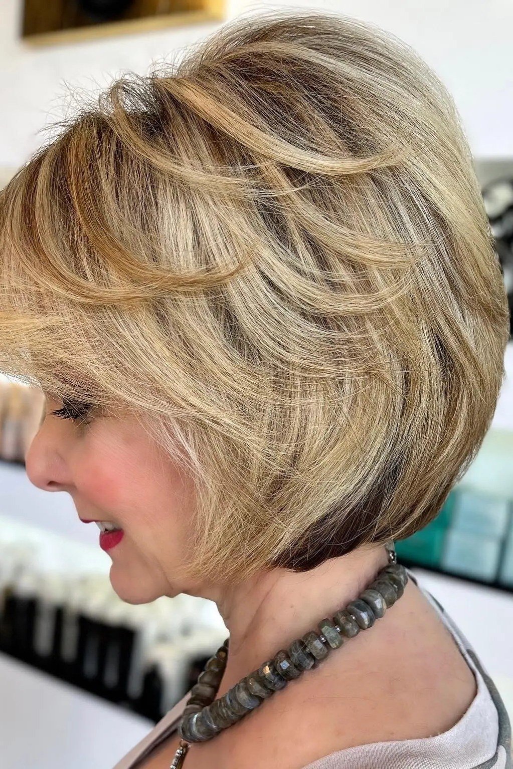 Big voluminous blonde layered bob, side view, mature - voluminous layered bob hairstyle for women over 50