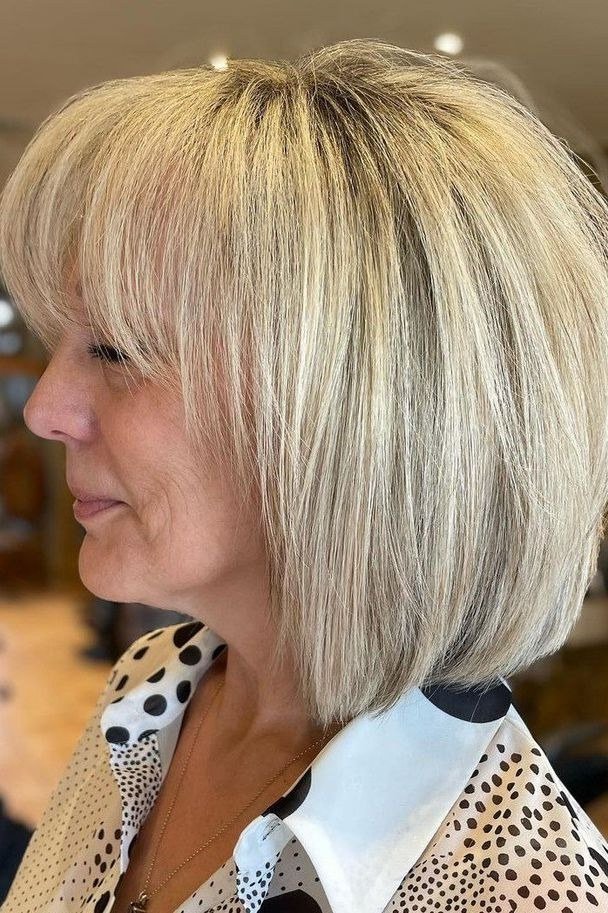 Blonde layered bob, side view, mature - voluminous layered bob hairstyle for women over 50