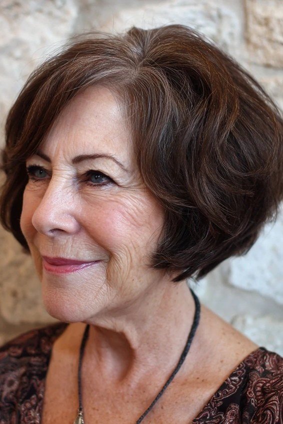 Dark voluminous layered bob, front view, mature - voluminous layered bob hairstyle for women over 50