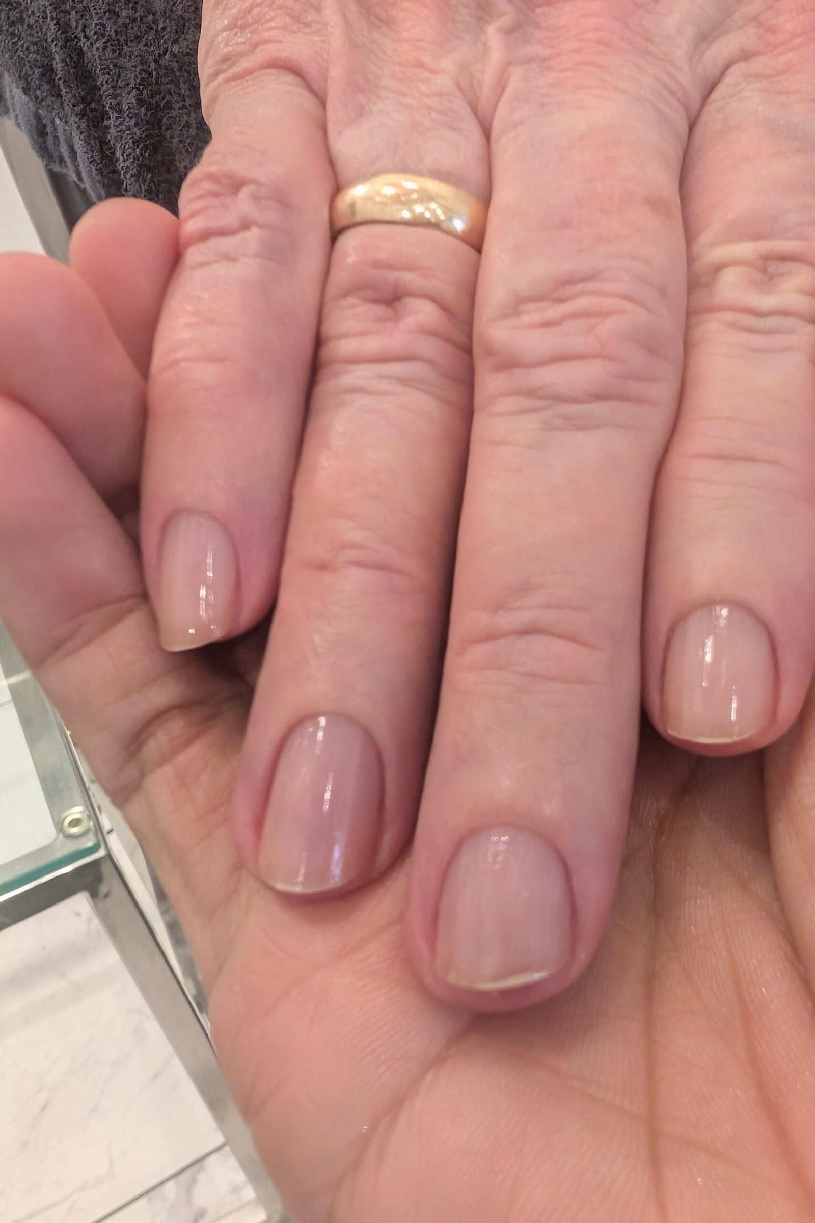 Pink nude almond nails with gold band for women over 50