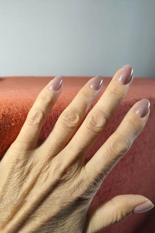 Warm taupe nude almond nails for women over 50