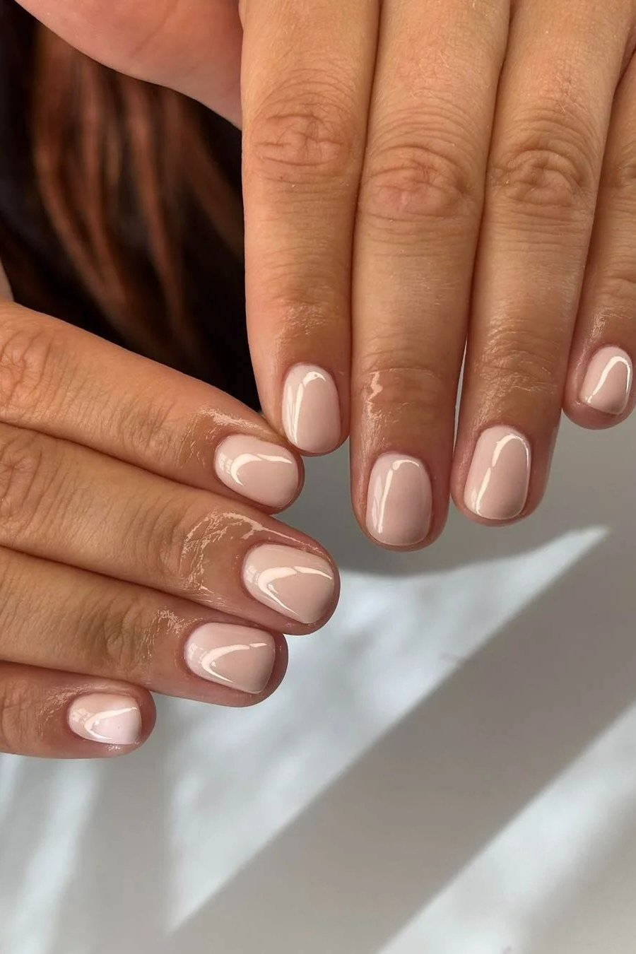 Warm beige nude almond nails for women over 50