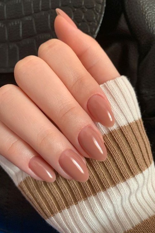 Warm terracotta nude short almond nails for women over 50