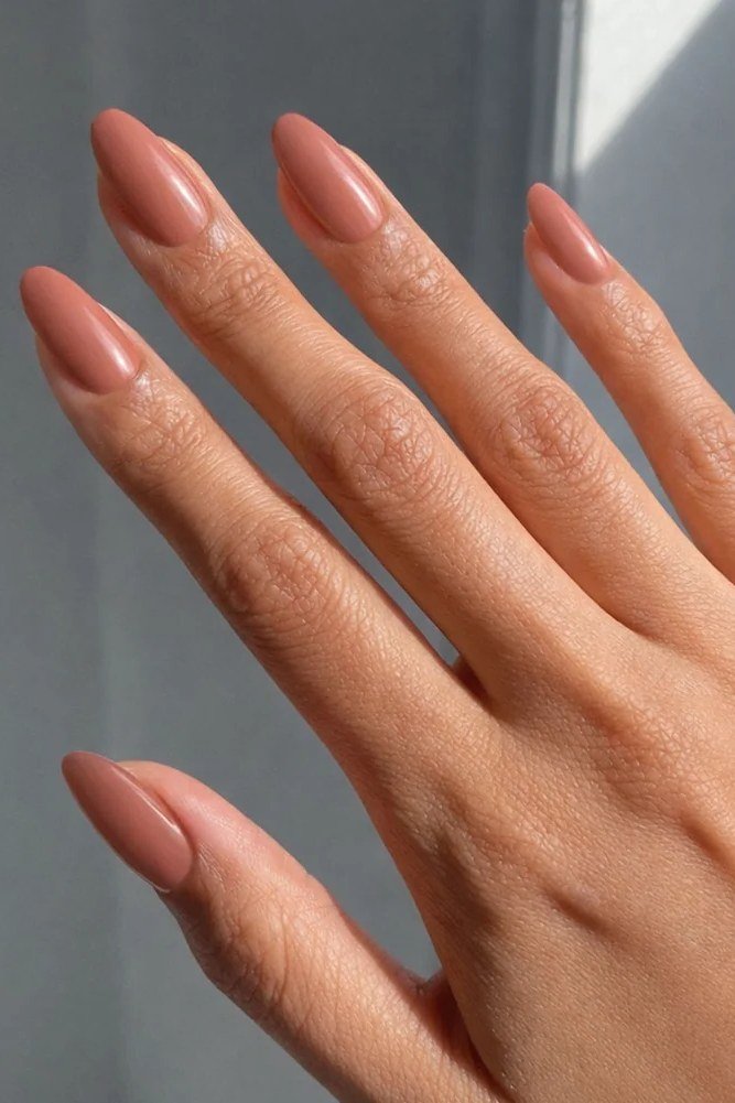 Warm terracotta short almond nails for women over 50