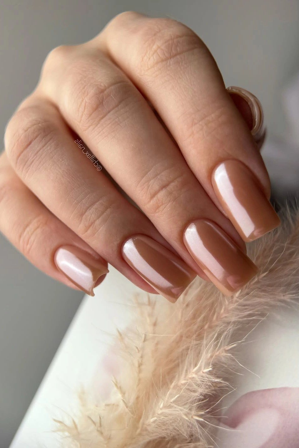 Glossy copper nude almond nails for women over 50