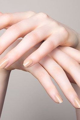 Pale nude artistic crossed hands for women over 50