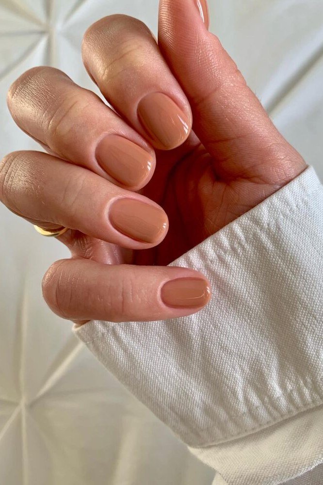 Warm terracotta short almond nails for women over 50