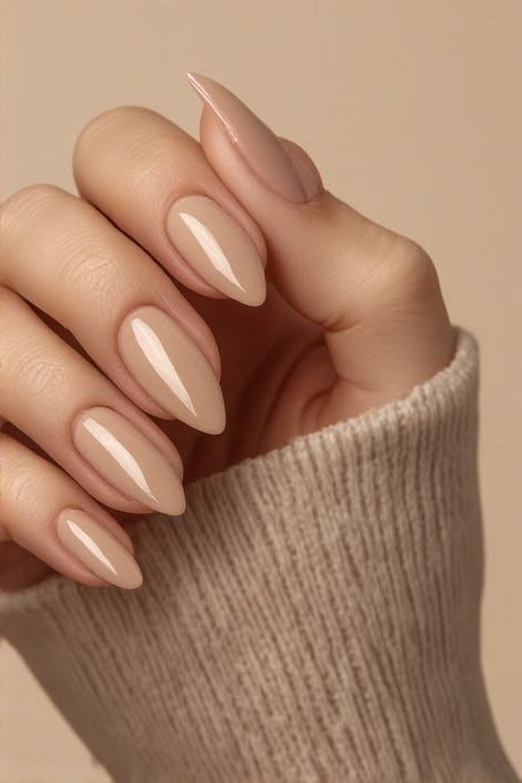 Warm beige nude almond nails for women over 50