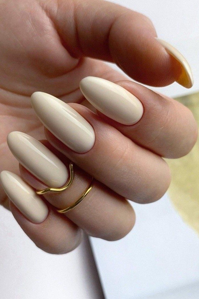 Milky nude almond nails with gold ring for women over 50