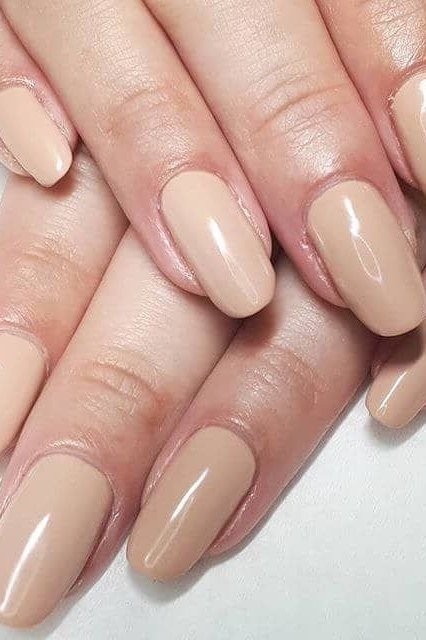 Warm beige nude almond nails two hands for women over 50