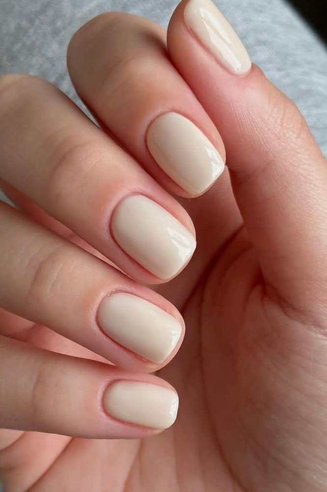 Warm beige nude short oval nails for women over 50