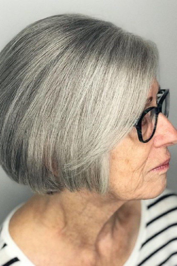 Silver rounded bob, side view, glasses, striped top - wash and wear haircut for women over 60