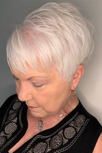 White pixie, looking down, black top - wash and wear haircut for women over 60