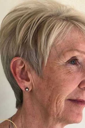 Blonde pixie, side view, gold earring - wash and wear haircut for women over 60