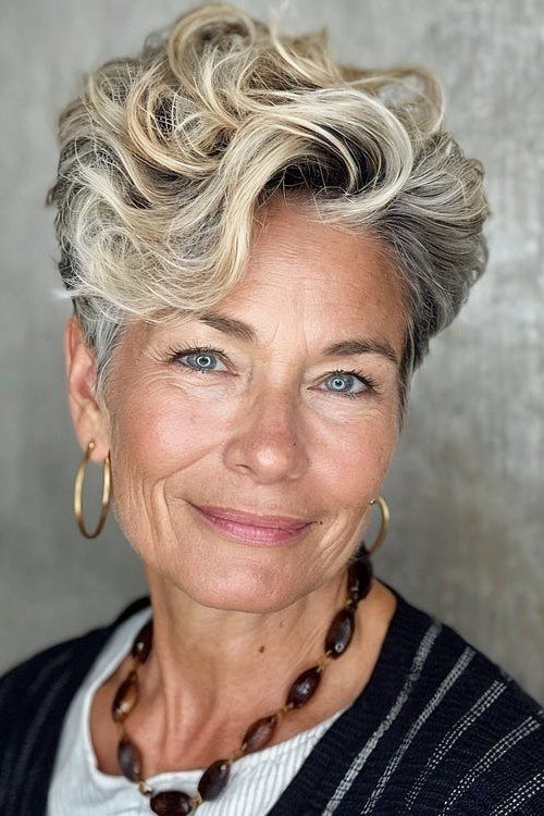 Curly blonde-grey pixie, front, gold hoops - wash and wear haircut for women over 60