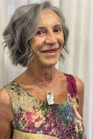 Grey wavy chin-length cut, front, elderly, floral top - wash and wear haircut for women over 60