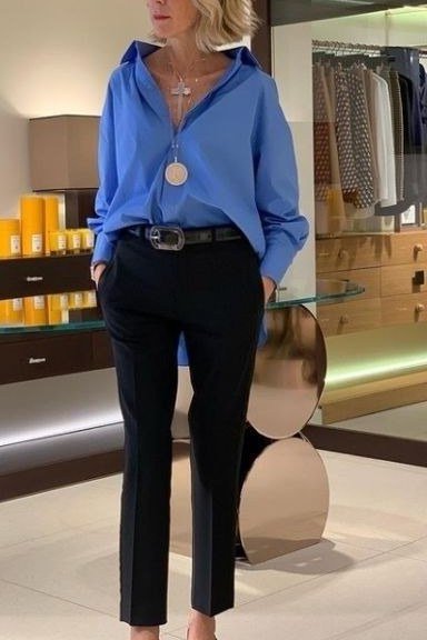 Business casual outfit for women over 50: cobalt blue blouse with black cropped trousers